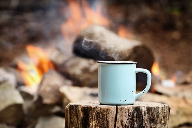 coffee-story Steaming Coffee in an enamel camping cup